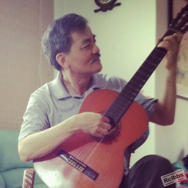 Me playing guitar. I bought this guitar when I was two and thirty. 33 years ago.